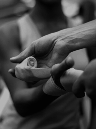 Woman's hand being bandaged by a medical worker after an injury [Mobile crop]