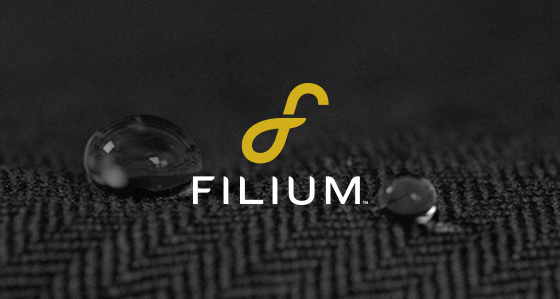 Filium logo on textured fabric with water droplets