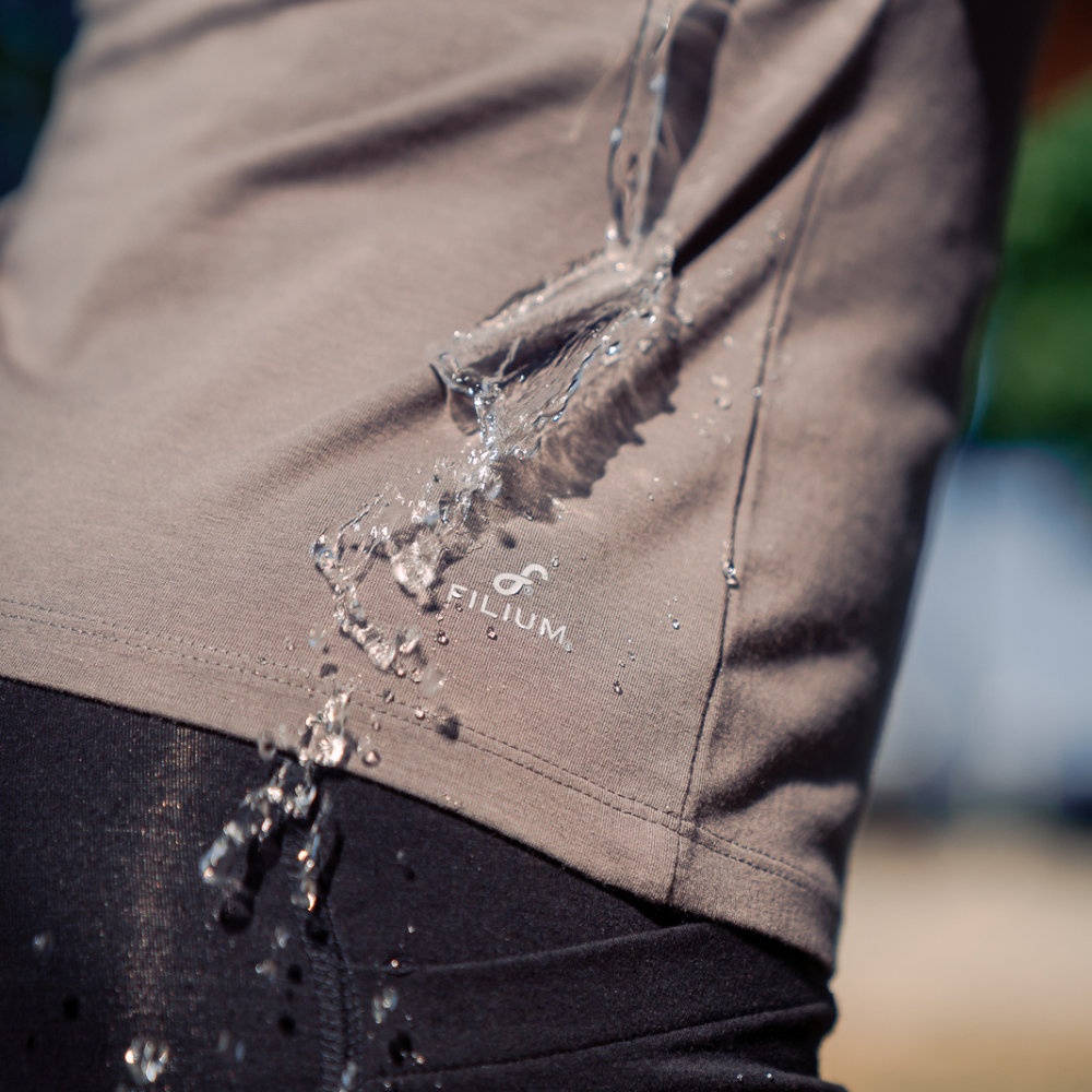 Gray t-shirt showing water running off to demonstrate the water repellent technology